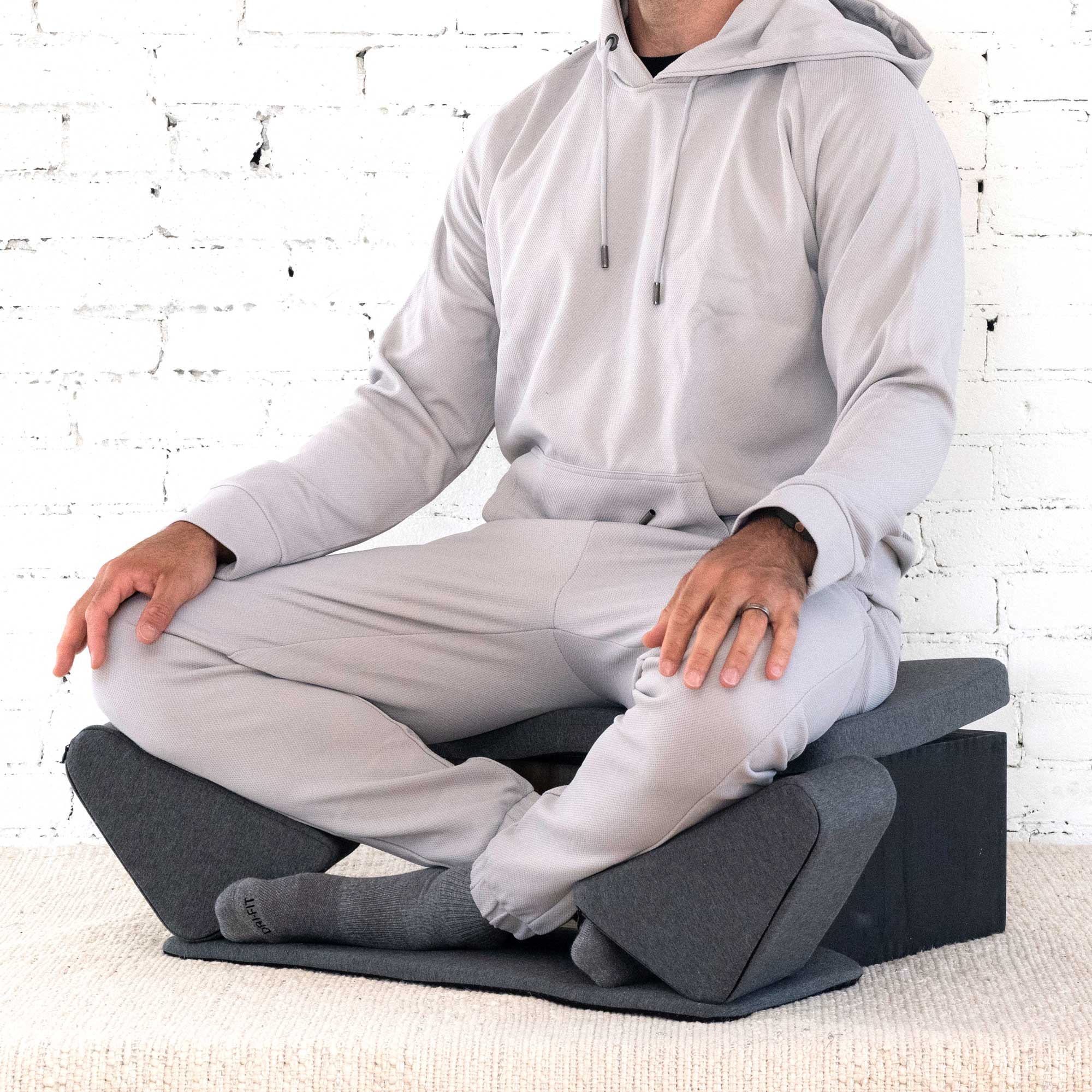 Portable Ungloo Meditation Chair with back and hip support, shown in box packaging, designed for comfortable seated meditation.