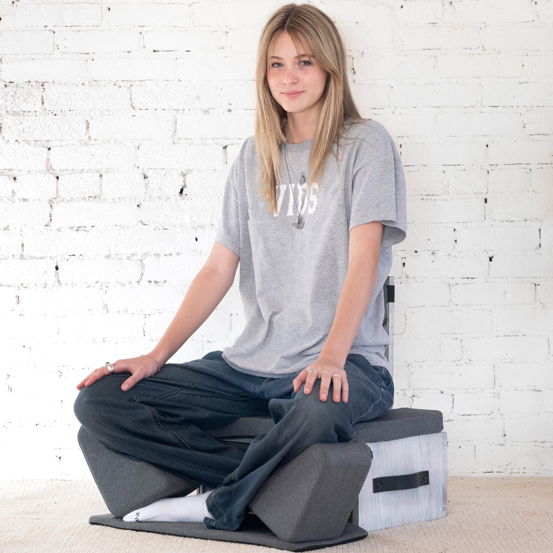Gray Ungloo Box portable meditation chair with back and hip support, shown from a three-quarter view