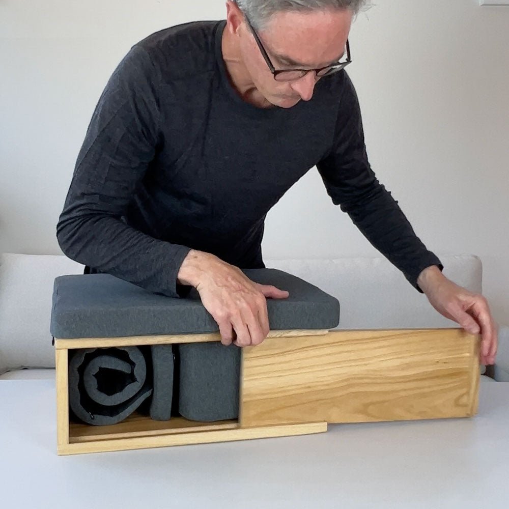 Portable Ungloo Box meditation chair with back and hip support, shown with Perry closing front panel in natural setting.