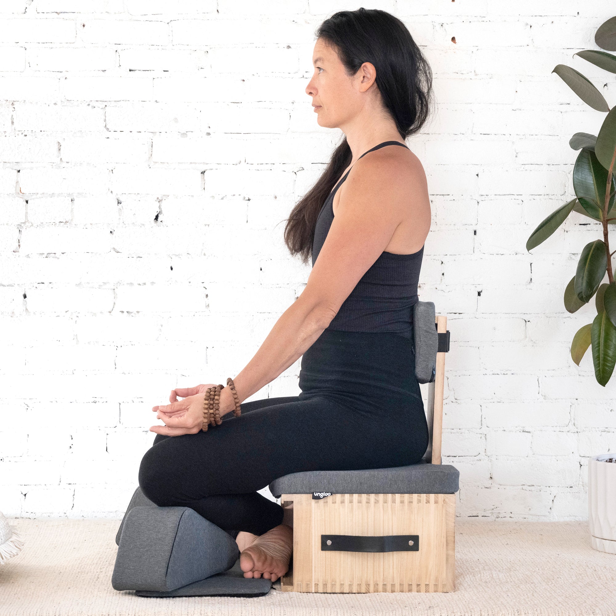 Profile view of Ungloo Box portable meditation chair with back and hip support, designed for comfortable seated meditation.