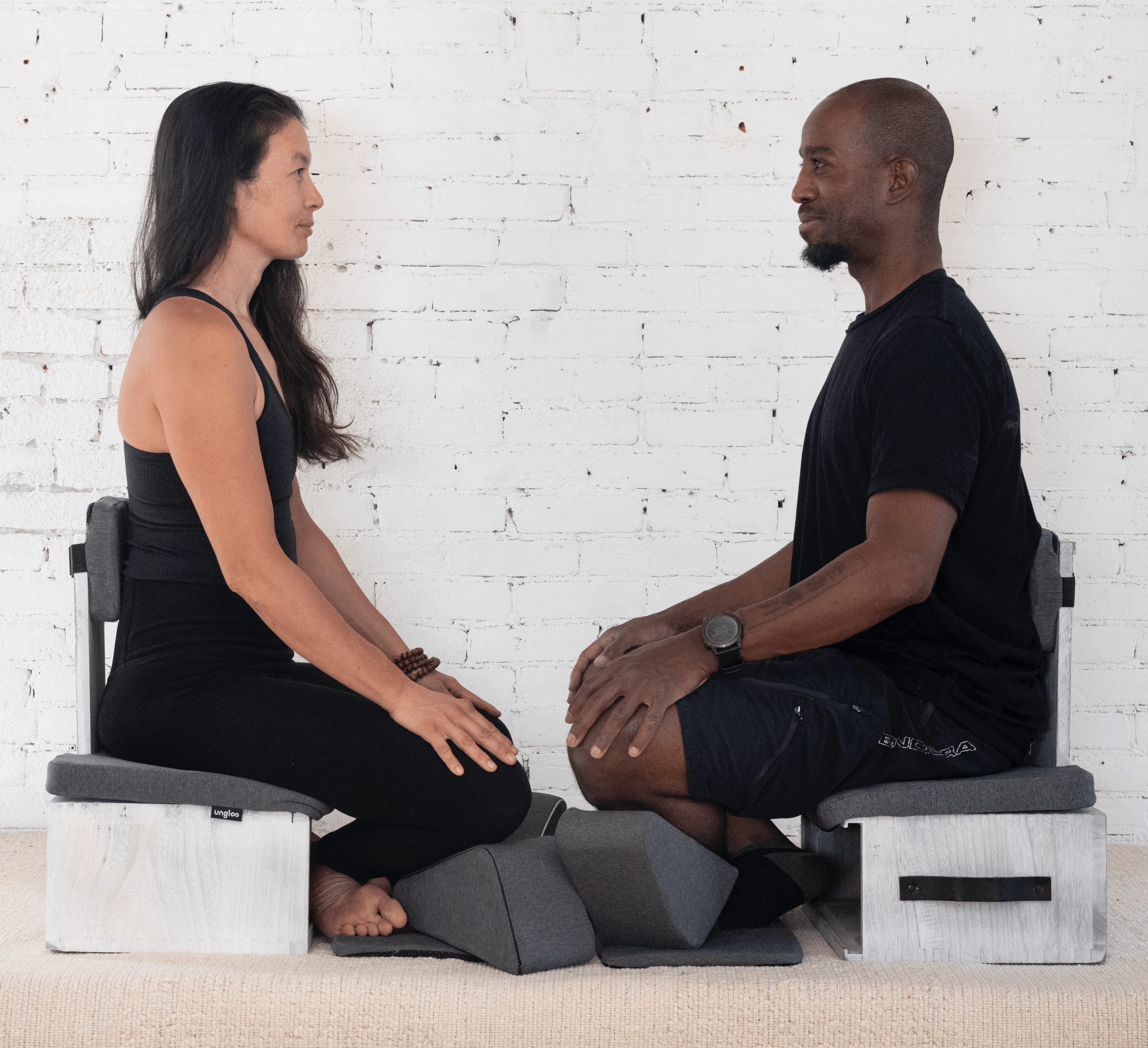 Gray Ungloo portable meditation chair with back and hip support, designed for comfortable seated meditation.